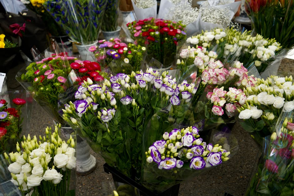 A vibrant display of fresh floral arrangements at Barnet Florist, featuring a variety of colourful flowers including white lisianthus, purple and white freesias, pink and white roses, and red and pink